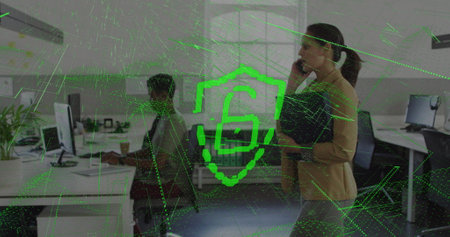 Image of padlock and shield over biracial businesswoman on phone walking through office. Global...