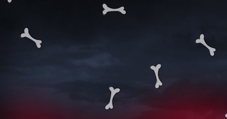 Image of bone icons over sky with clouds. Abstract background and digital interface concept digitally generated image.の写真素材