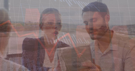 Image of multiple graphs and caucasian coworkers discussing over tablet against river. Digital composite, multiple exposure, data, report, business, technology, nature and office concept.の写真素材