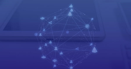 Image of connected dots forming globe over overhead view of digital tablet and laptop on table....