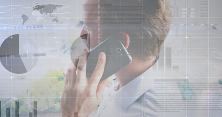 Image of statistical data processing against caucasian man talking on smartphone at office. Computer interface and business data technology conceptの写真素材
