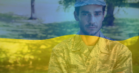 Image of flag of ukraine over biracial male soldier. ukraine crisis and international politics concept digitally generated image.の写真素材