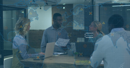 Image of world map over african american man discussing with diverse colleagues at office. Global...