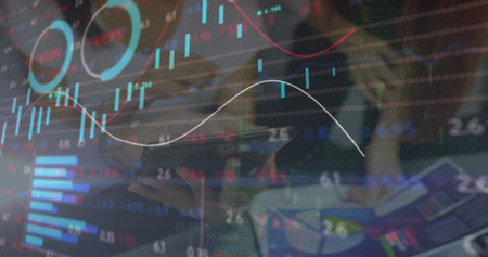 Image of financial data processing over diverse business people using tablet. Global business, finances and digital interface concept digitally generated image.の写真素材