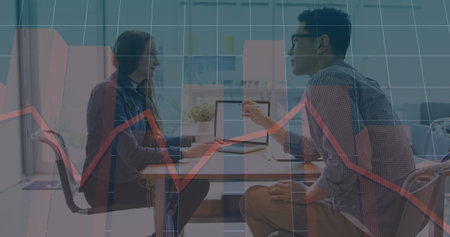 Image of multiple graphs, female manager discussing reports with male coworker on laptop. Digital...