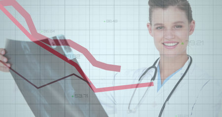 Image of statistical data processing over caucasian female doctor examining x-ray report. Medical healthcare technology conceptの写真素材