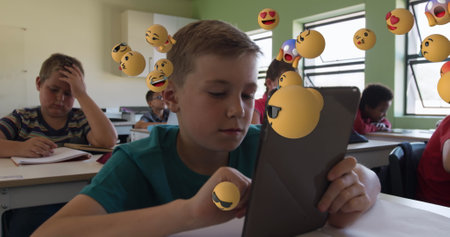 Image of multiple emoticons floating over diverse students studying and using digital tablet....