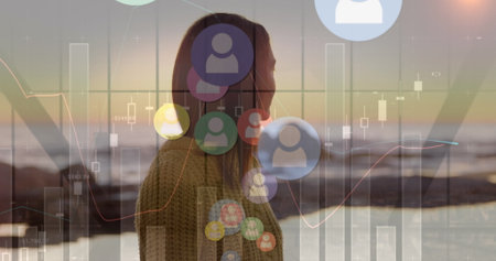 Image of falling social media icons over woman on the beach. Social media and communication concept digitally generated image.の写真素材