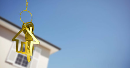 Image of golden key and house over house and blue sky. Moving house and business concept digitally generated image.の写真素材