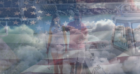 Independence text and waving american flag over couple with fishing rods on a boat against clouds. american independence and celebration conceptの写真素材