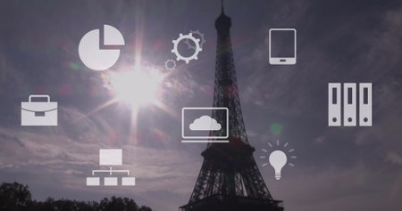 Image of multiple icons over eiffel tower against sun and cloudy sky. Digital composite, multiple exposure, ideas, report, business, cloud computing, architecture and technology concept.の写真素材