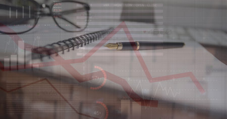 Image of statistical data processing over close up of a pen, glasses and diary on office table. Computer interface and business data technology conceptの写真素材