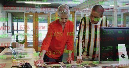 Image of trading board over diverse coworkers discussing on desk in office. Digital composite,...
