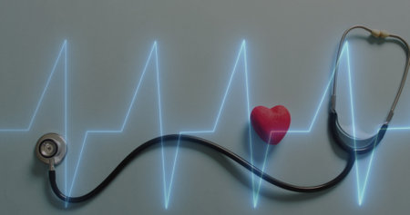 Image of heart rate montior against close up of stethoscope and red heart on grey surface. Medical healthcare and research science technology conceptの写真素材