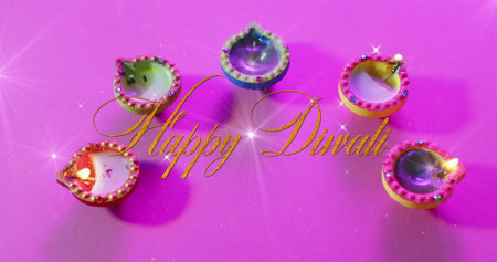Image of happy diwali text over candles on purple background. Diwali, indian tradition and celebration concept digitally generated image.の写真素材