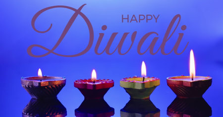 Image of diwali text over candles on purple background. Diwali, indian tradition and celebration concept digitally generated image.の写真素材