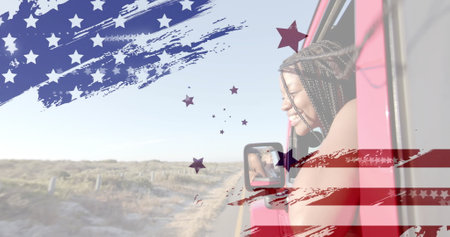 Image of flag of usa over happy african american woman in car by beach in summer. American...