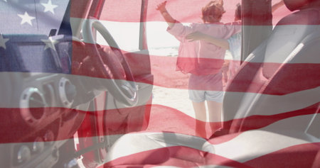 Image of flag of usa over caucasian woman getting out of car on beach. American patriotism, diversity and vacation concept digitally generated image.の写真素材