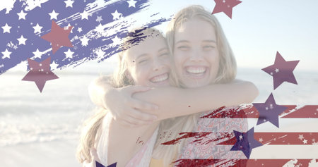 Image of flag of usa and stars over caucasian female friends on beach. Patriotism and celebration concept digitally generated image.の写真素材