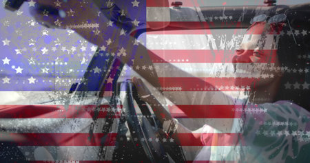 Image of flag of usa over african american woman in car on beach. American patriotism, diversity and vacation concept digitally generated image.の写真素材