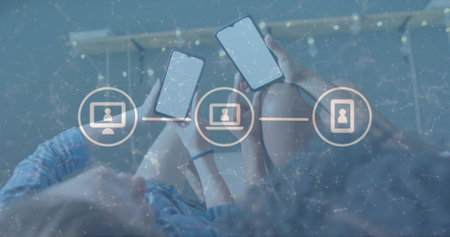 Image of icons and data processing over diverse women using smartphones. Global artificial intelligence, connections, computing and data processing concept digitally generated image.の写真素材