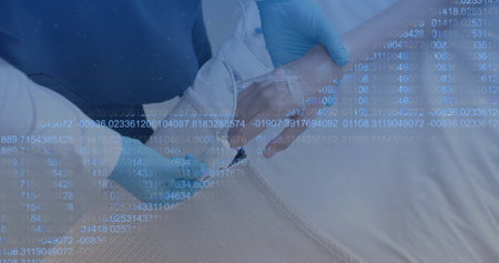 Administering IV drip, healthcare professional wearing gloves providing patient care. Medical, nurse, treatment, intravenous, hospital, injectionの写真素材