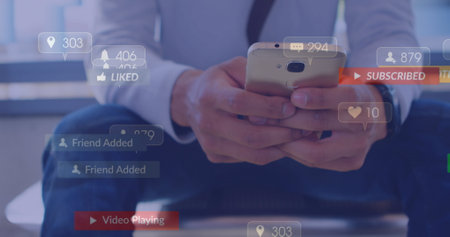 Image of social media icons falling against mid section of businessman using smartphone. Social...