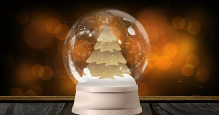 Image of christmas snow globe over spots. Christmas, tradition and digital interface concept digitally generated image.の写真素材