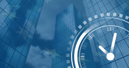 Image of ticking clock icon over low angle of tall buildings against waving eu flag. Computer interface and business technology conceptの写真素材
