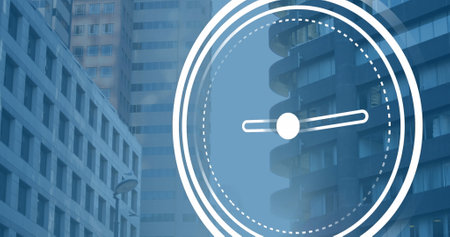 Image of ticking clock icon against view of tall buildings. Computer interface and business technology conceptの写真素材