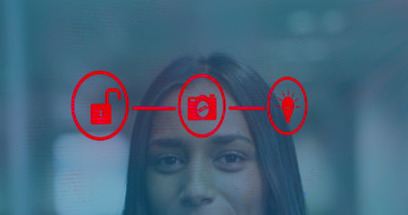 Image of connected icons over close-up of smiling biracial woman standing in office. Digital...