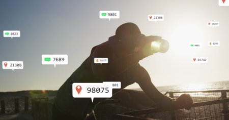 Image of notification icons and changing numbers, thirsty african american man drinking water. Digital composite, exercise, fitness, athlete, tired, mobile apps, social media, technology.の写真素材