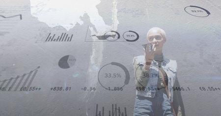 Image of graphs and trading board over short hair biracial woman talking on speaker of cellphone. Digital composite, multiple exposure, report, business, stock market and technology concept.の写真素材