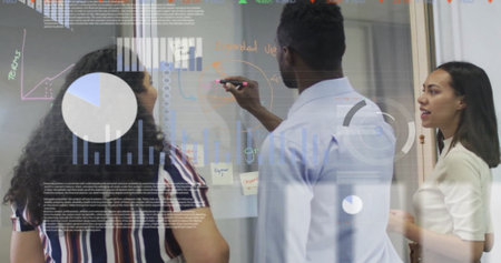 Image of multiple graphs, trading board over diverse coworkers discussing strategy on whiteboard. Digital composite, multiple exposure, business, stock market, planning and teamwork concept.の写真素材