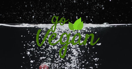 Image of go vegan text over fruit falling in water background. Eating healthily, vegan food and...