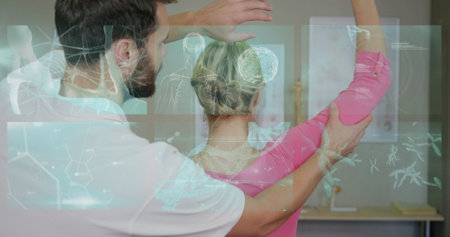 Image of medical data processing over caucasian male massage therapist with female patient. massage at work and digital interface concept digitally generated image.の写真素材