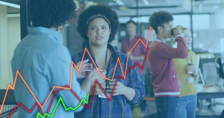 Image of colorful graphs moving against diverse man and woman discussing at office. Computer interface and business data technology conceptの写真素材