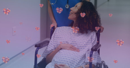 Image of heart icons over happy biracial pregnant woman talking with nurse. maternal mental health awareness week concept digitally generated image.の写真素材
