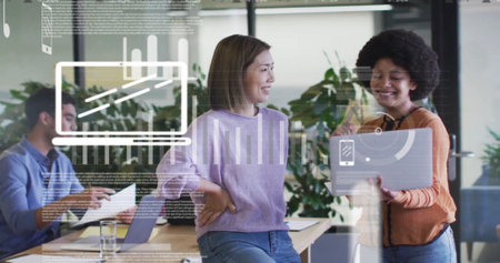 Image of graphs, icons and trading board over diverse coworkers discussing reports on laptop....