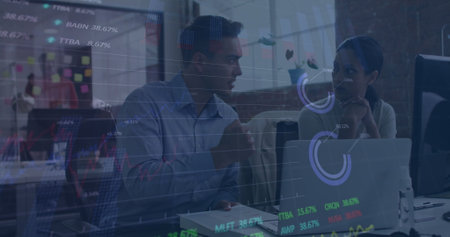 Image of stock market data processing against diverse man and woman discussing at office. Global...