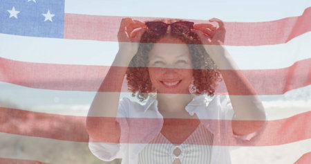 Image of flag of usa over happy diverse friends on beach in summer. American patriotism, diversity and vacation concept digitally generated image.の写真素材