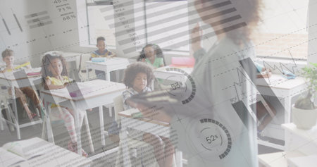 Image of data processing over happy diverse female teacher addressing pupils in class. Communication, school, childhood, education and learning, digitally generated image.の写真素材