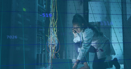 Image of data processing over african american it woman by computer servers. Global computing, digital interface and data processing concept digitally generated image.の写真素材