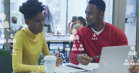 Image of digital icons over diverse business people in office. Global business, finances, computing and data processing concept digitally generated image.の写真素材