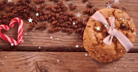 Imaged of falling stars over cookies and coffee beans. Christmas, tradition and celebration concept digitally generated image.の写真素材