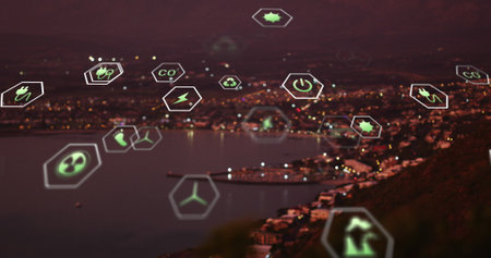 Image of sustainability and ecology icons over landscape. Ecology, sustainability and data processing concept digitally generated imageの写真素材