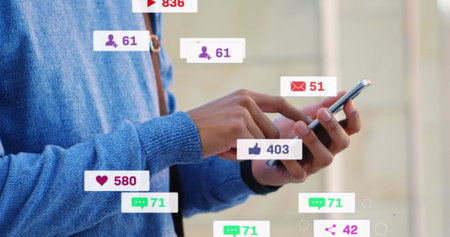 Image of media icons over caucasian man using smartphone. Social media and digital interface concept...