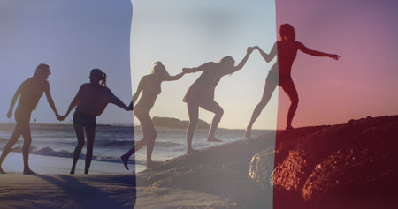 Image of flag of france over diverse friends at beach. Fete nationale francaise, patriotism and celebration concept digitally generated image.の写真素材