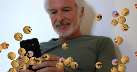 Image of emoticons floating over caucasian senior man using smartphone. global network, connections,...