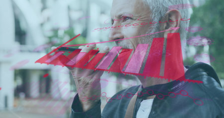 Image of financial graph over caucasian senior man using smartphone. business, finance and technology concept digitally generated image.の写真素材